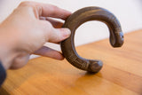 Handcrafted African snake cuff held to show scale and intricate etched geometric patterns.
