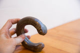 Angled view of the handmade etched patterns on an antique African snake cuff.