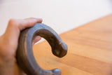 Hand-etched patterns and aged patina on the head of an antique African snake cuff bracelet.