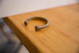 Profile view of the antique African snake cuff highlighting its open design and aged finish.