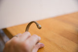 Close-up of the antique snake cuff's sculpted head showing its aged patina.