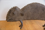 Close-up of vintage African chameleon figure, highlighting textured body and aged patina.