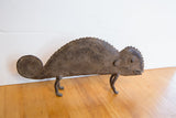 Etched pattern and coiled tail detail of the vintage African chameleon figure.