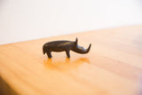 Vintage African rhino sculpture with dark patina, showing its distinct handmade form.