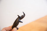 Vintage African rhino sculpture, dark patina, simple handmade shape held in hand.