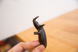 Collectible vintage African rhino sculpture held in hand, highlighting its dark patina.