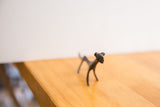 The handmade face and dark patina of a vintage African cheetah collectible.