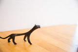 The elegant, stylized form of a vintage cheetah sculpture, seen in profile.
