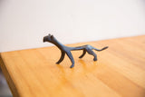 Vintage cheetah sculpture in profile, highlighting its stylized form and dark patina.