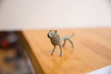Side profile view highlighting the textured, oxidized finish of the vintage lion figure.