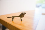 Side profile of the vintage African oxidized lion, highlighting its slender, handmade form.