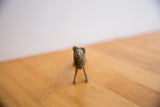 Front view of the vintage African lion collectible, showcasing its dark, aged, handmade texture.