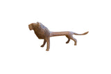 Vintage handmade African lion sculpture with a rustic, textured patina.