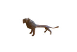 Vintage handmade African lion sculpture with a rustic, dark textured finish.