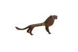 Vintage African lion sculpture in profile with a stylized, elongated body and a rich dark patina.