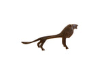 Vintage African lion sculpture with a stylized, elongated form and dark, textured patina.