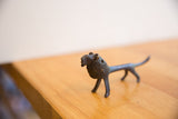 Side view of the vintage African lion figure showing its textured body and dark patina.