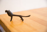 Angled detail of the vintage lion's head showing its handmade texture and dark patina.