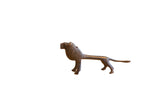 Vintage African lion sculpture with a dark patina and an elongated, stylized form.
