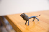 Side profile of the vintage African lion collectible highlighting its dark patina and textured mane.