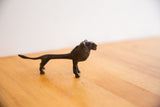 Side profile view of the vintage African lion sculpture showing its dark, textured patina.