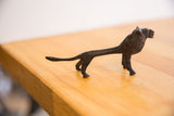 Angled profile view of the vintage African lion's elongated, handmade body.