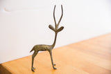 Vintage oxidized gazelle sculpture showing its full left-facing profile and handmade texture.