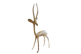 Vintage left-facing African gazelle sculpture with a slender body and weathered oxidized finish.