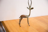 Side view of the vintage African gazelle, highlighting its aged metal finish and slender body.