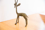 Side profile of the vintage gazelle sculpture showing its slender, oxidized form.