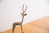 Left-facing profile of a vintage African gazelle with a textured, oxidized patina.