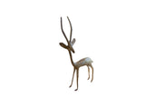 Vintage African left-facing gazelle sculpture with a slender form and an oxidized patina.