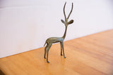 Collectible vintage African gazelle sculpture, handcrafted with rich greenish-brown patina.