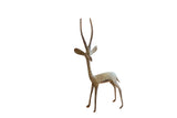 Handmade vintage African gazelle sculpture with a weathered, oxidized patina, facing left.