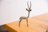 Brightly patinated African gazelle sculpture, highlighting graceful neck and curved horns.
