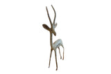 Vintage left-facing African gazelle sculpture with a weathered, brightly oxidized finish.