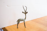 Side view of a vintage African gazelle sculpture with its unique oxidized patina.