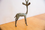 The slender form and bright oxidized patina of the vintage African gazelle sculpture.