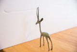 Vintage handmade African gazelle sculpture, left facing, with bright green patina.