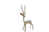 Vintage African gazelle sculpture with a bright oxidized patina and tall slender horns.