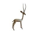 Vintage African gazelle sculpture in a right-facing pose with a time-softened oxidized finish.