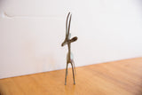 Three-quarter view of the vintage oxidized gazelle showing its slim body and graceful horns.