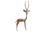 Vintage African gazelle sculpture with a weathered, oxidized patina and tall horns.