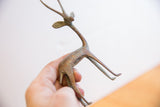 Side profile of the vintage gazelle sculpture highlighting its aged, oxidized metal texture.