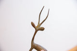 Detail of the vintage gazelle's stylized head, showing its oxidized texture.