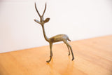 Side profile of a vintage African gazelle showing its slender form and oxidized patina.