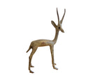 Collectible vintage African gazelle sculpture with a rustic oxidized patina, facing right.