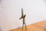 Angled close-up of the vintage gazelle's head, showing its slender horns and oxidized finish.
