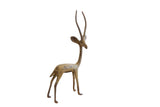 Vintage African gazelle sculpture facing right, with a slender form and mottled oxidized finish.