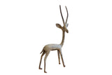 Vintage African right-facing gazelle sculpture with a slender form and oxidized patina.